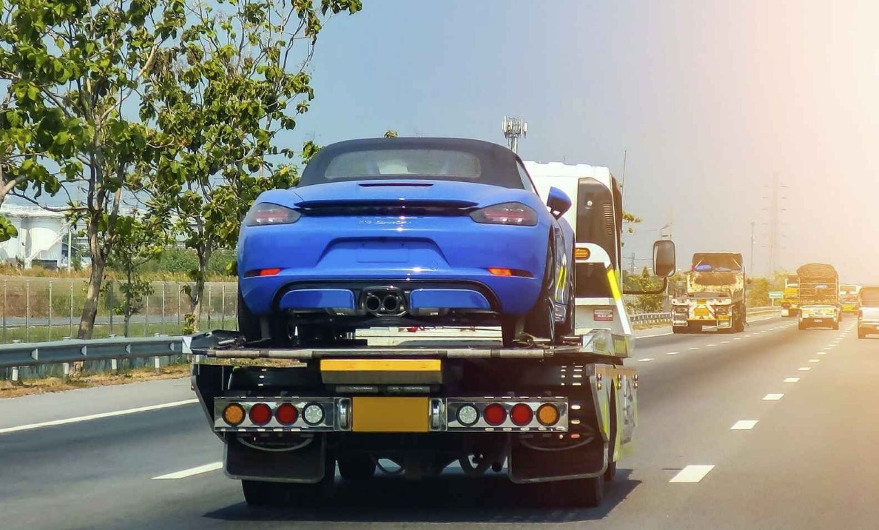 Flatbed towing service safely transporting a luxury sports car in Woonsocket, RI